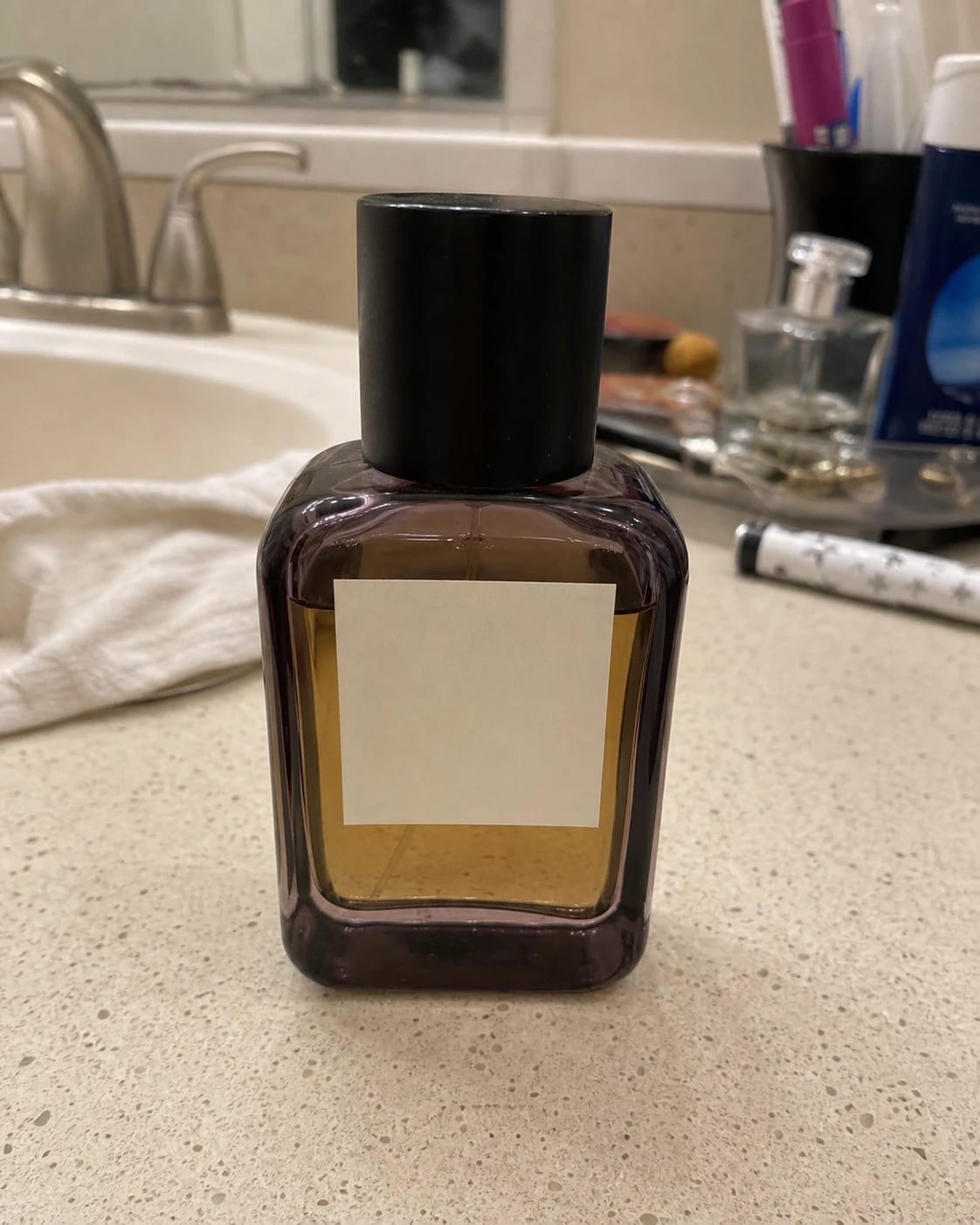 Ordinary phone snapshot of a perfume bottle on a bathroom counter